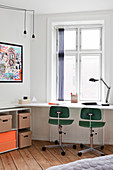 Simple White desk with two vintage swivel chairs in front of the window