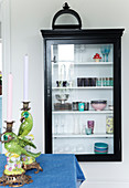 Black cupboard with glass door on the wall