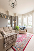 Classic living room with bay window and stucco elements in period building