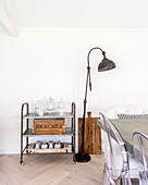 Vintage serving trolley and standard lamp in dining area