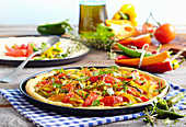 Pizza peperonata with pepperoni, peppers, tomatoes and rosemary