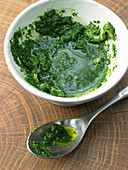 Basil oil in a small bowl