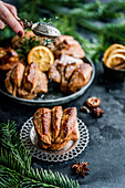 Orange gingerbread pastries dusted with powdered sugar