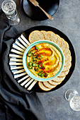 Spicy white bean dip served with crackers and jicama sticks