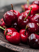 Fresh red cherries in a wooden bowl