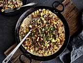 Fried chanterelle mushrooms with potatoes and minced meat in a creamy sauce