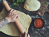 Pizza dough being rolled out