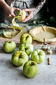 Preparing apple pie, peeling apples, cake in a mold