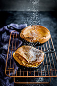 Baked pancakes sprinkled with powdered sugar
