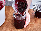 Cherry jam being transferred to jars