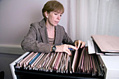 Woman filing patient records