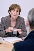 Chiropractor discussing treatments with a patient