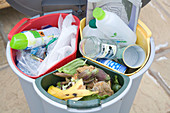 Rubbish in a triple household recycling bin