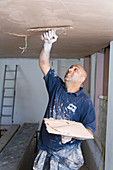 Man plastering the ceiling