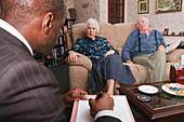 Social worker with elderly couple at home