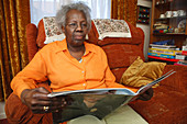 Elderly woman looking at magazine