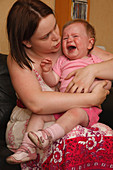 Portrait of mother with crying baby