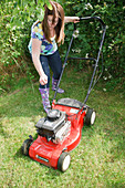 Woman starting lawnmower