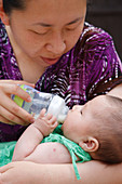 Chinese mother feeding baby