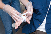First Aid Officer bandaging a colleague's injured hand