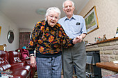 Elderly carer helping his wife with Alzheimer's disease