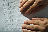 Visually-impaired person reading Braille