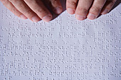 Visually-impaired person reading Braille