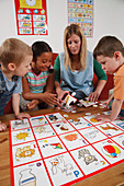 Nursery nurse doing a puzzle with children
