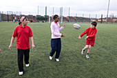Group of children practicing rugby