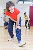 Woman stretching her legs in an aerobics class