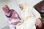 Older woman sharing a joke with younger woman