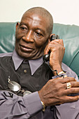 Older man answering the telephone