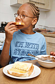 Boy eating toast