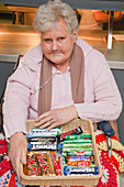 Wheelchair user selling sweets in tuck shop