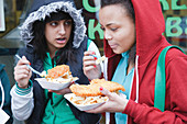 Teenagers eating fish and chips