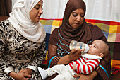 Health visitor visiting mother with baby