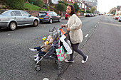Mother crossing road with twins in buggy