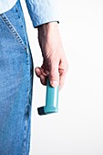 Close-up of hand holding an asthma inhaler