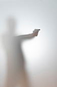 Blurred silhouette of a man with a gun
