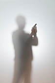 Blurred silhouette of a man with a gun