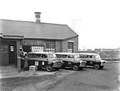 Vans being loaded outside TV repair depot, 1959