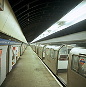 Tube train standing at Blackhorse Road station, London, 1974