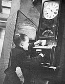 Boy clocking on at the Trocadero Restaurant, London, c1939