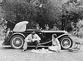 Couple having a picnic by an MG TA Midget, late 1930s
