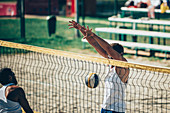 Beach volleyball players at the net