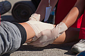 Paramedic treating a knee injury