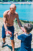 Grandfather and grandson boxing