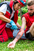 Medical worker treating burns on man's arm