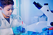 Schoolboy using lab equipment
