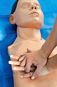 Chest compressions on CPR dummy